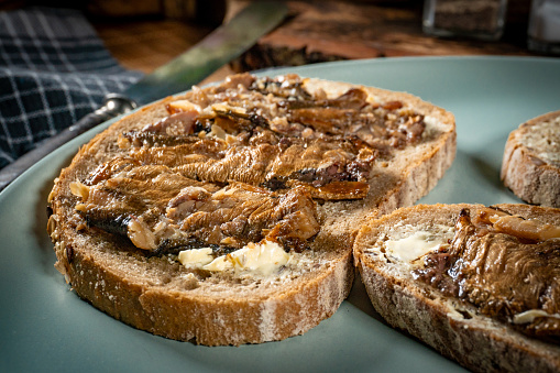 Slices of multigrain bread with sprats.