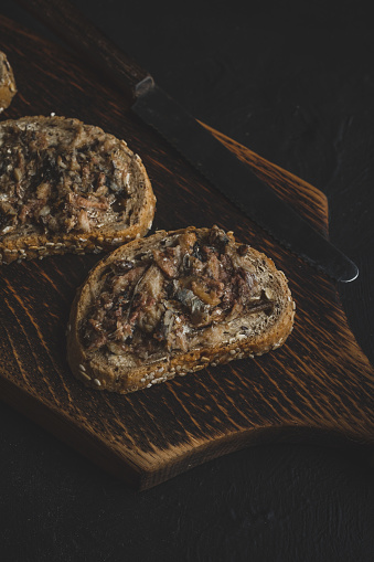 Slices of multigrain bread with sprats.