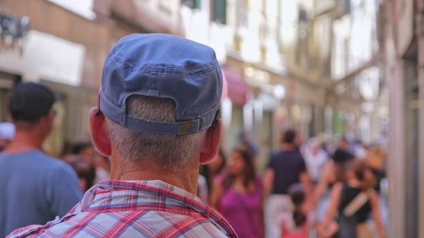 istock Senior man walking outdoors in urban location 2123403405