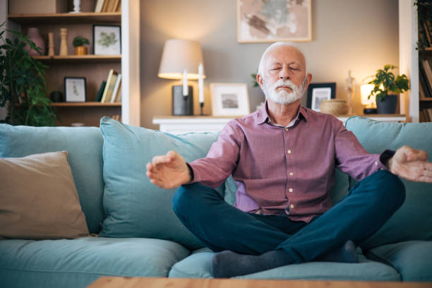 istock senior man meditates at home. 2123410687