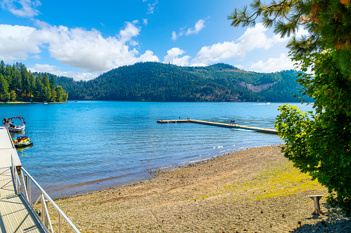 Summer day view of docks and beaches at rural Spirit Lake, a 1,534 acre lake in the small historic turn of the century town of Spirit Lake, Idaho, a suburb of the general Coeur d'Alene area of the North Idaho panhandle region.