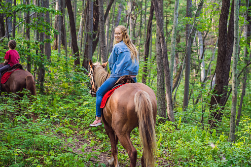 Beautifulwoman riding a horse in countryside.