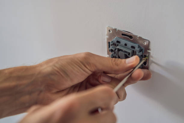 istock Master electrician installs a socket in the house 2123493776