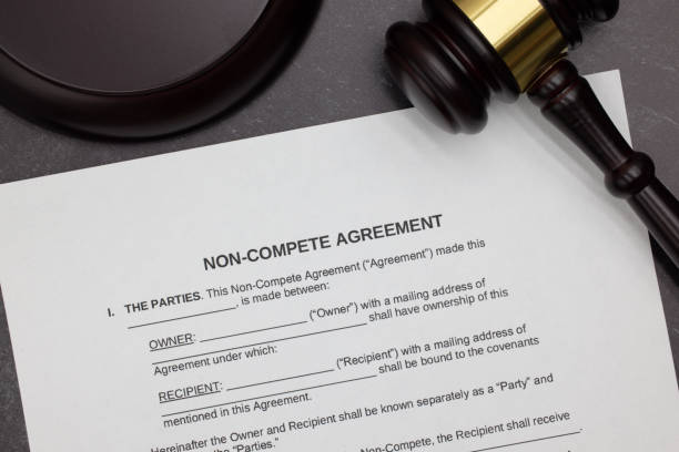 istock Non-Compete agreement legal form with gavel and block on slate desktop 2123496357