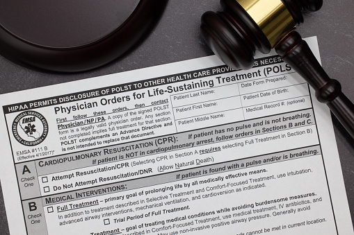 HIPAA POLST Physician Orders for Life-Sustaining Treatment legal form with gavel and block on slate desktop