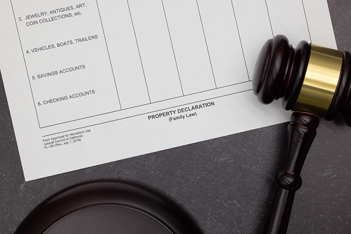 Family Law Property Declaration legal form with gavel and block on slate desktop.  Divorce