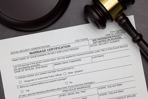 Marriage Certification request legal form with gavel and block on slate desktop