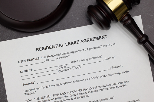 Residential Lease Agreement with gavel and block on slate desktop