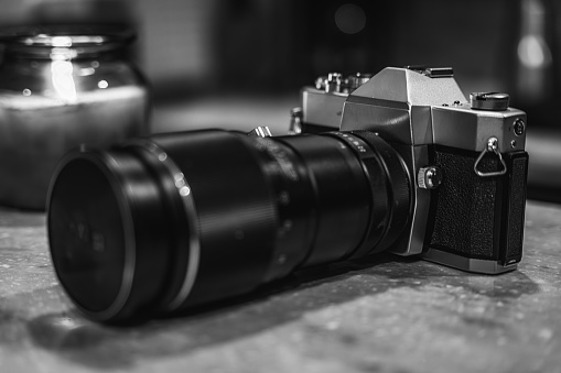 Close up of Black Digital Rangefinder camera in indoor setting.