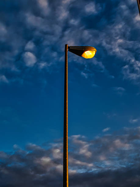istock street lamp at dusk in a cloudy sky 2123566702