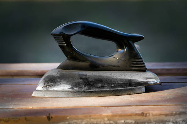 Closeup of a retro iron from the 1960s on a white background.