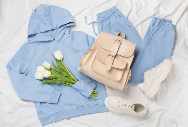 istock Flat lay with trendy spring outfit and flowers on white sheet background 2123588618