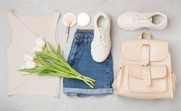 istock Flat lay with trendy spring outfit and flowers on concrete background 2123588622