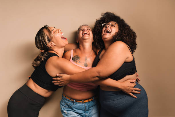 istock Different women hugging each other laughing together 2123600891