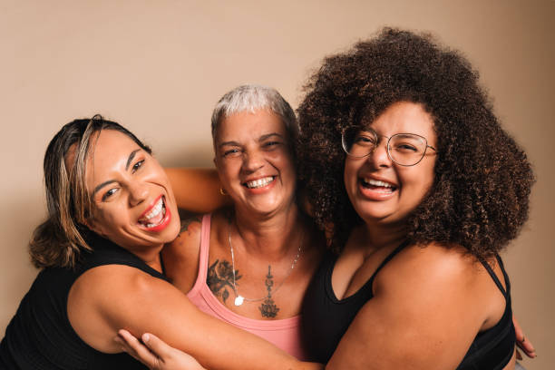 istock Women hugging each other laughing 2123600913