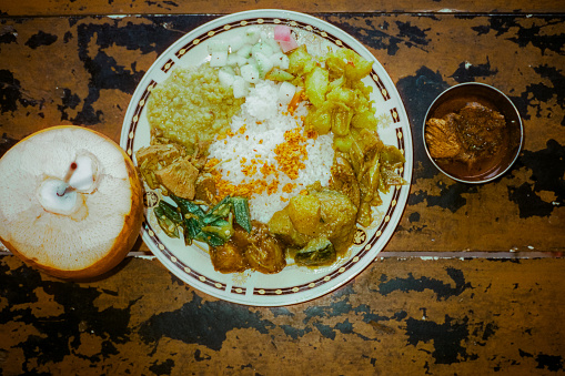 Sri Lankan curry and fresh coconut on the table shot directly above