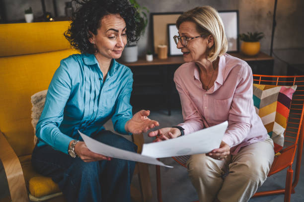 istock two women work on project at home hold document have consultation 2123645268