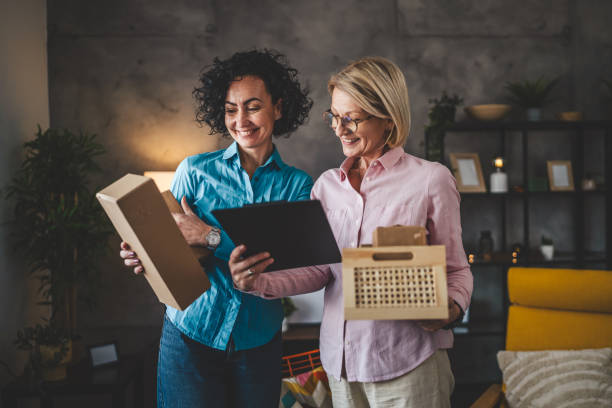 istock two women entrepreneur at home pack boxes product order for delivery 2123660245