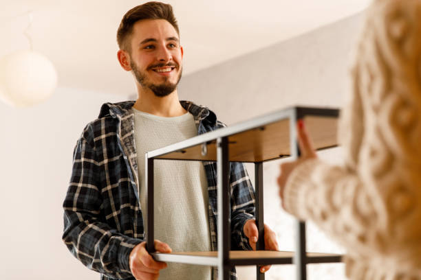istock Young man carrying a shelf with his girlfriend 2123679466