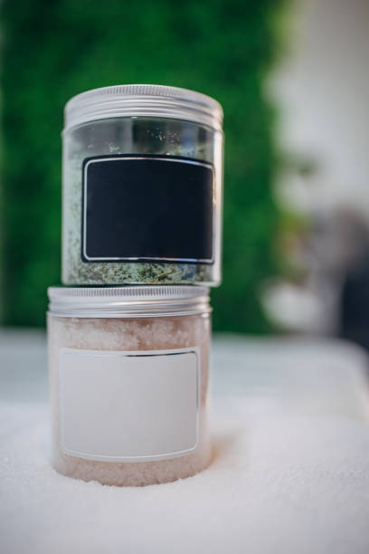 A close-up image of jars filled with foot scrub, made from natural ingredients, promising smooth and soft skin. Pamper your feet with this rejuvenating treatment. Perfect for a relaxing spa day at home