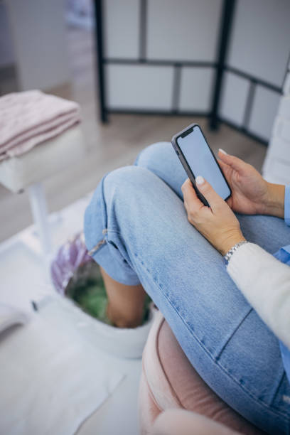 istock Woman sitting and using smartphone 2123695728