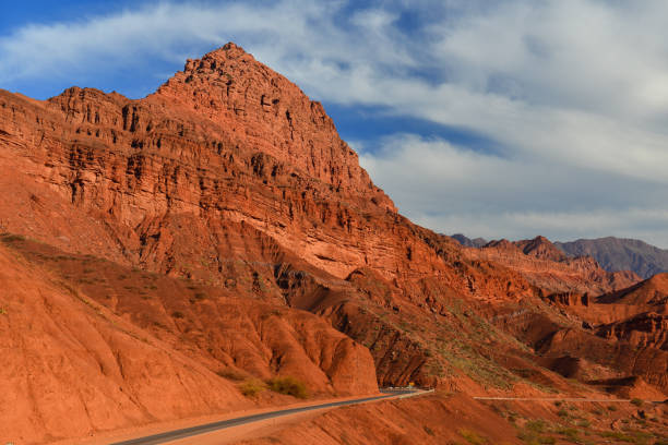 The famous Route 40 paved road parallel to the Andean mountains against a blue sky, Jujuy Province. Argentina 2014 (Selective focus on the road)