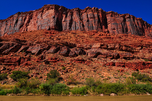 The Colorado river cutting through the red sandstone walls on the Utah State Route 128, the Upper Colorado River Scenic Byway, upstream from Moab, Utah, southwest USA.