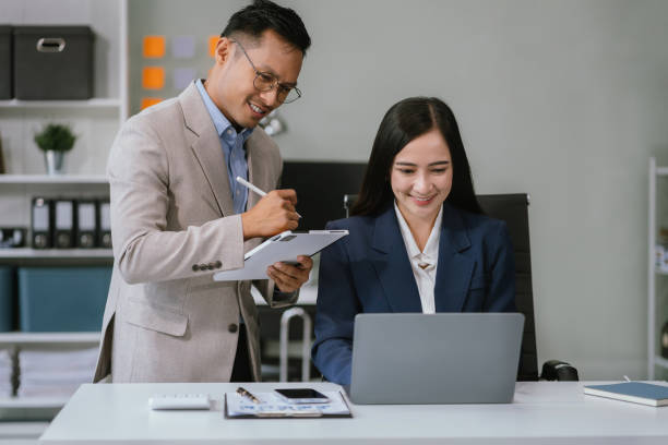 istock Teamwork process, Business team using a calculator to calculate the numbers of statistic business profits growth rate on documents graph data. 2123816739