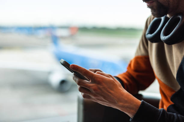 istock Man using phone at airport 2123816819