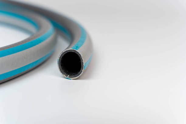 Coiled flexible pvc garden hose on a white background with ample copy space for adding text or designs. Perfect for product demonstrations or advertising materials.