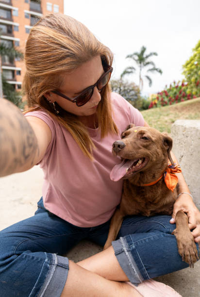 istock A woman lovingly looks at her dog while taking a selfie. 2123889892