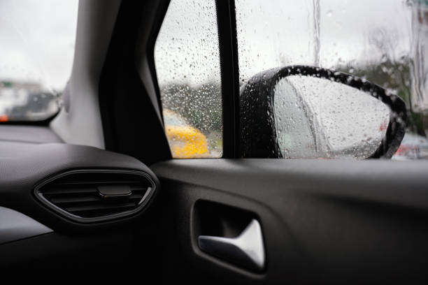 istock Raindrops reflected on the car glass and rearview mirror on a rainy day 2123894022