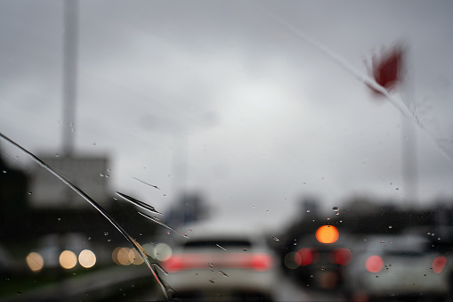 In Istanbul traffic on a rainy day, car wipers clean raindrops from the car window