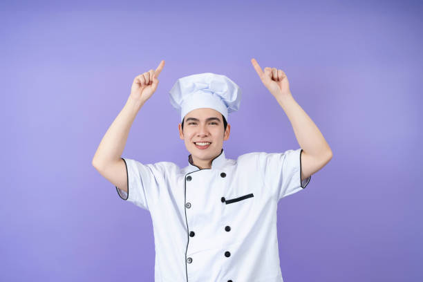 istock Young Asian male chef on background 2123945221