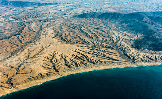 Geologic features of Baja California  from an airplane showing erosion, valley; desert. The landscape is the result of erosion by water and wind in a desert climate, with torrential rain in summer and strong wind in spring.
