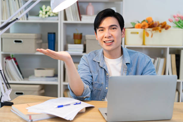 istock Young Asian businessman working at home 2123971271