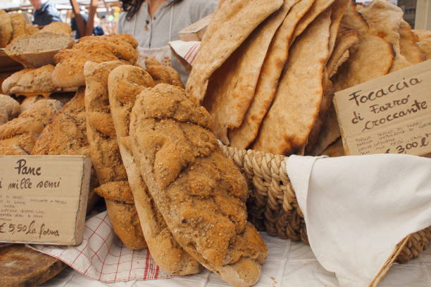 Customers Browsing a Stall with Traditional Artisan Bread at an Outdoor Country Market