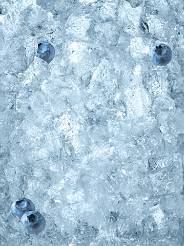 Looking down on blueberries laying on ice cubes