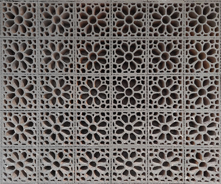 Close up pattern of moulded clay or ceramic latticework, or simply called as Roster, in flower pattern. Latticework is a moulded or cutout pattern made of wood, clays, or ceramic as a secondary skin wall finishes.