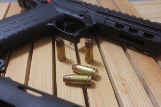 istock Semi Automatic Handgun on Wooden Table With Ammo 2124024719
