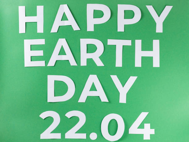istock Happy Earth Day Inscription on Green Background with Paper Letters 2124046813