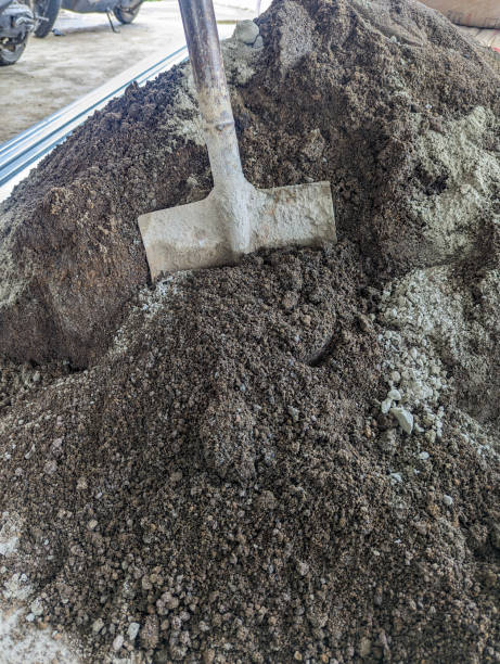 Shovel in pile of dirt on White.