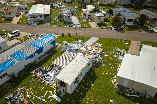 Badly damaged mobile homes after hurricane Ian in Florida residential area. Consequences of natural disaster.