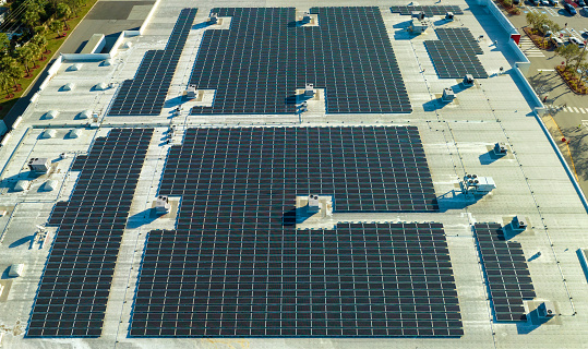 Aerial view of solar panels on factory roof.