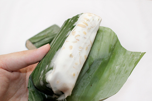 Normally soybeans are given the yeast and left packed for 2days , and wrapped in banana leaves for the selling. Can be fried or steamed, and mixed with other dishes. Indonesian traditional food.