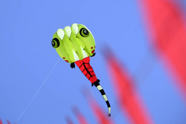 colorful green monster kites with blue sky background