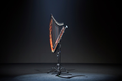 a harp is lit up on a stand with a string that says \