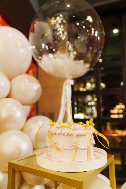 istock Festive cake, decorated with gold bows and a candle. 2124181307