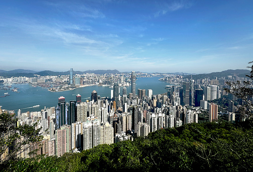 The Peak is actaully a Victoria Peak, a summit of a hill located at Hong Kong Island overlooking the skyscrapers of Hong Kong and Victoria Harbor from a height. Aerial view.