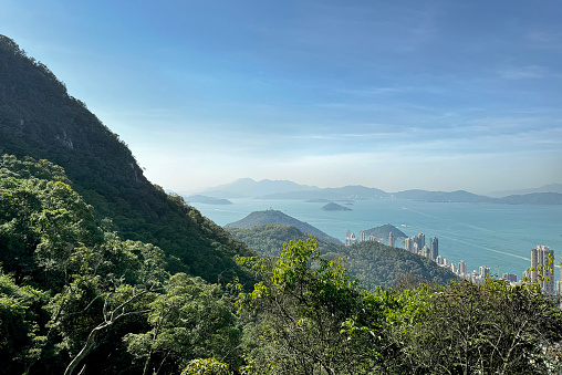 The Peak is actaully a Victoria Peak, a summit of a hill located at Hong Kong Island overlooking the skyscrapers of Hong Kong and Victoria Harbor from a height. Aerial view.